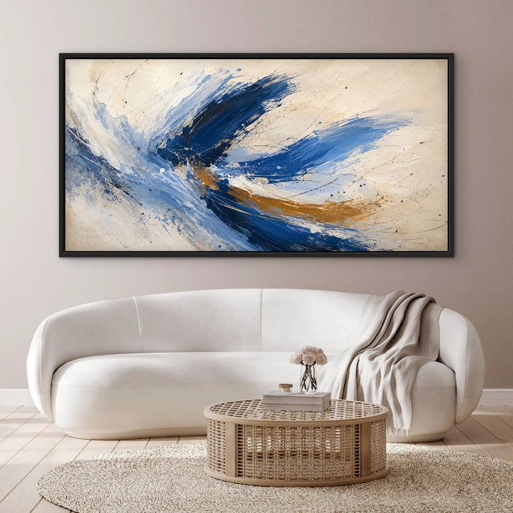 Cobalt Flight blue and gold panoramic abstract framed canvas above a curved cream sofa