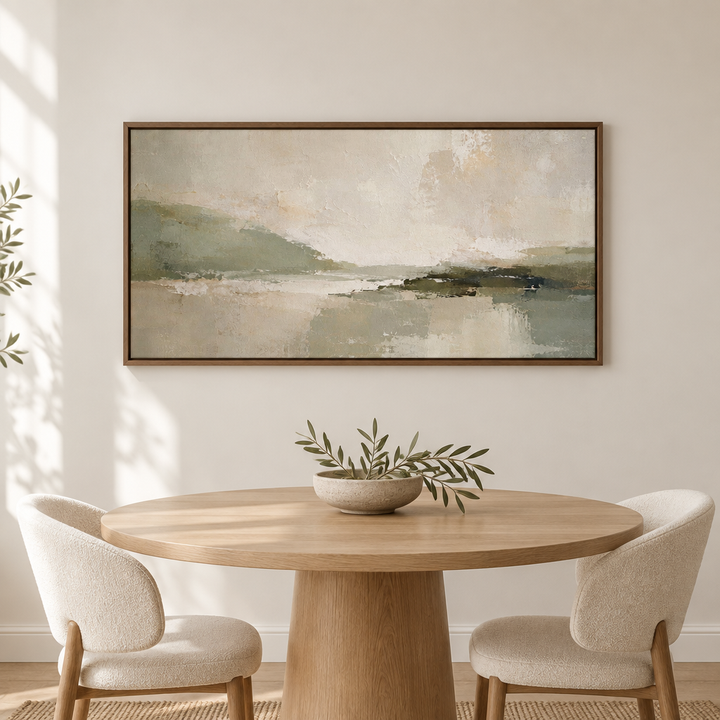 Green Essence sage green panoramic framed canvas in a brown wooden frame above a round oak dining table