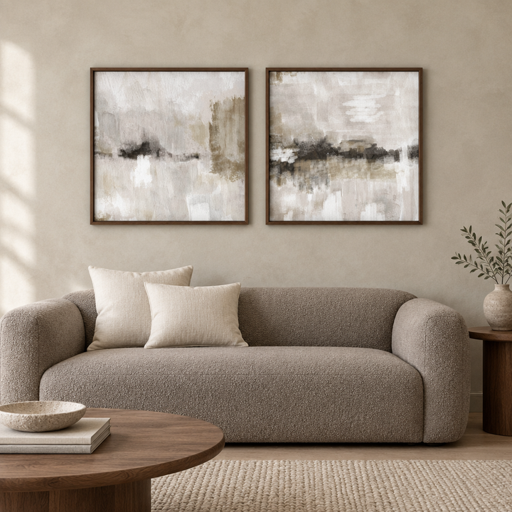 Nude Clouds set of two abstract framed canvases in brown wooden frames above a taupe boucle sofa