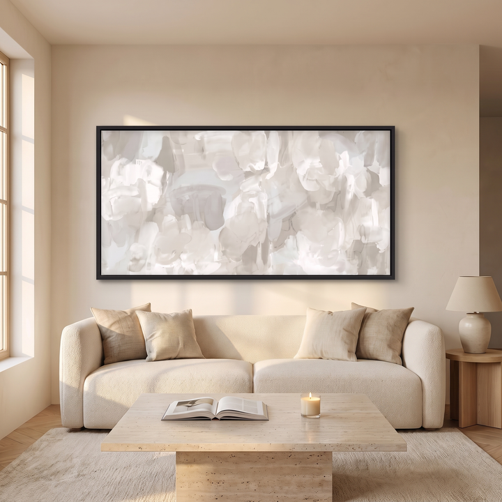 Whispered Mist panoramic framed canvas in black frame above a cream boucle sofa - neutral white and beige abstract wall art