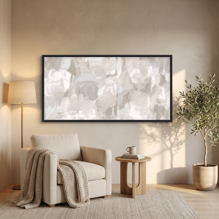 Whispered Mist panoramic framed canvas in black frame above a cream armchair reading corner - neutral abstract wall art